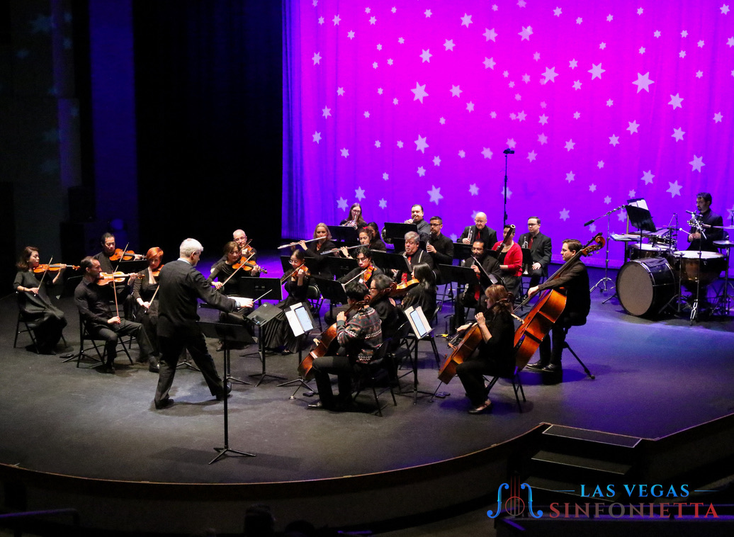 Las Vegas Sinfonietta performing under purple stage lights in Las Vegas